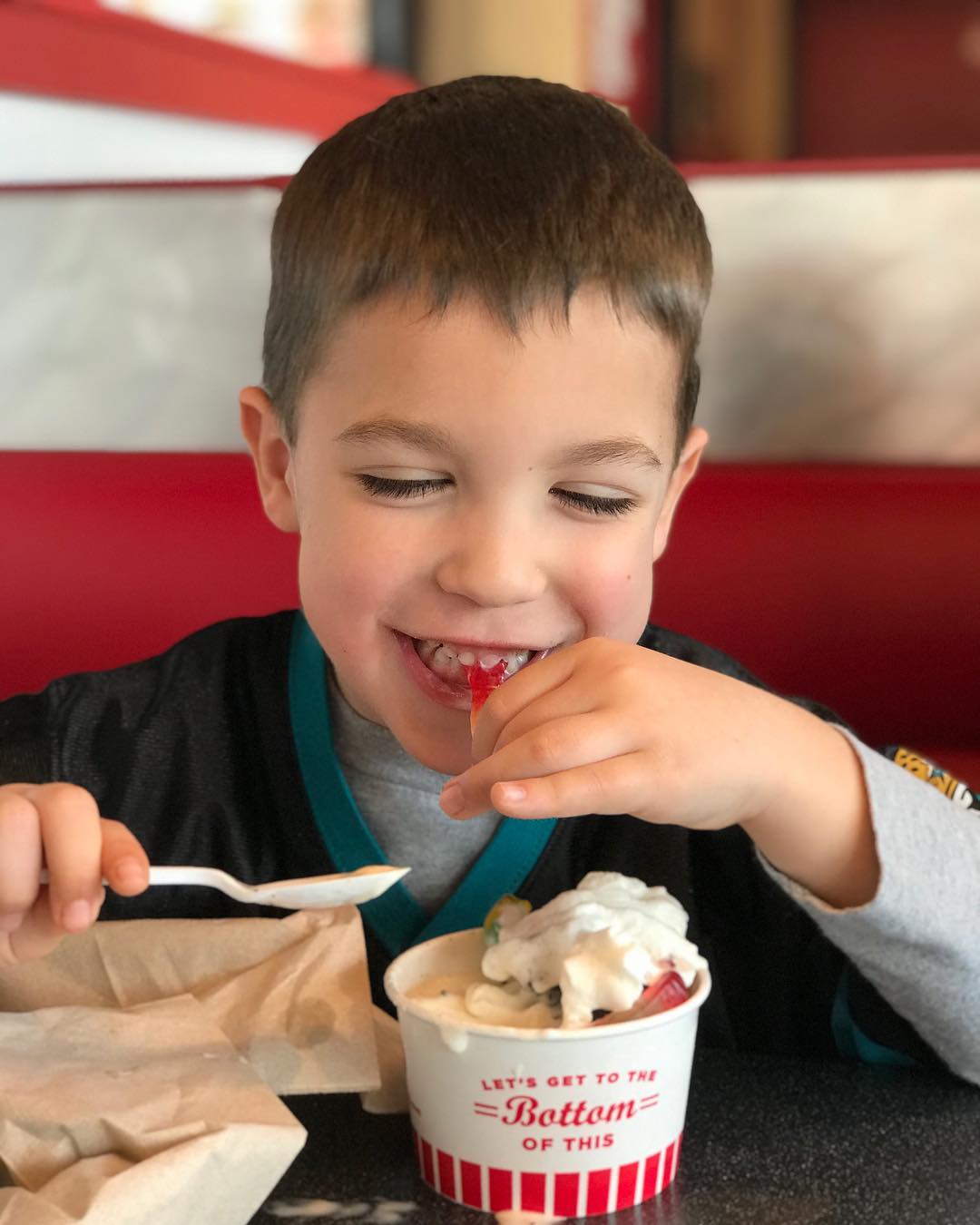 Young boy eating a sundae